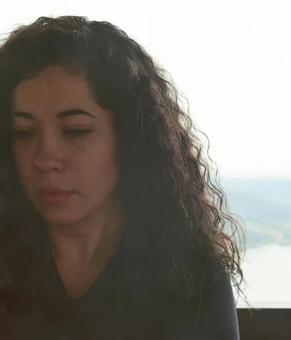 Person meditating peacefully with a soft glowing background.